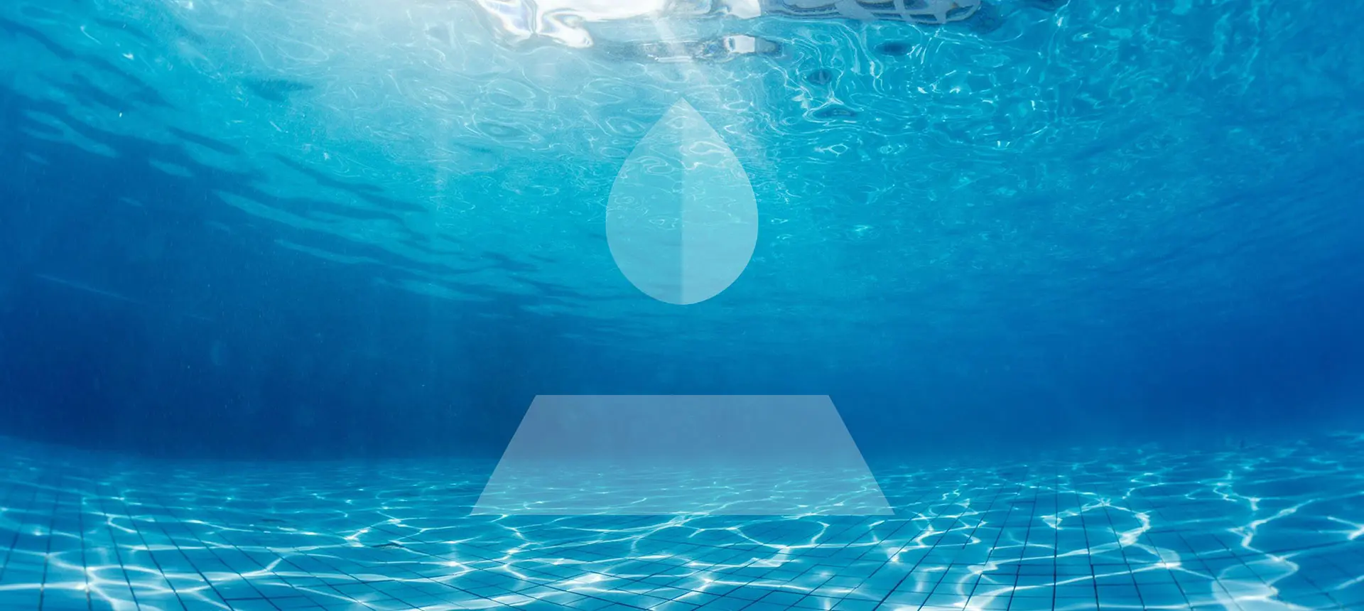 Water surface seen from the bottom of a swimming pool with sun rays passing through the water and reflecting on the bottom